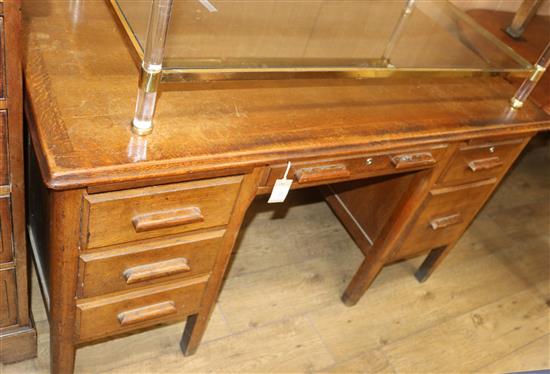 An oak six drawer desk W.137cm